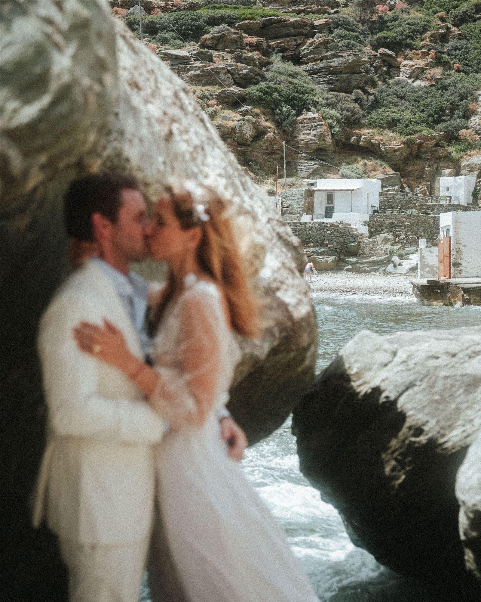 Aerial view of a couple kissing on a whitewashed coastal path above the water